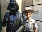 Women in park ranger uniform standing next to statue of Frederick Douglass