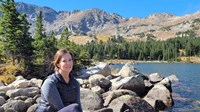 Amy Hribar sitting on rocks outdoors