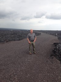 Mike Will standing on a gravel road outdoors.