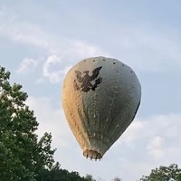 A hot air balloon floating above the ground.