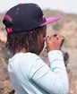 A child looks at a rock through a magnifying glass.