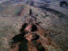 aerial photo of a line of volcanic cones and lava flows