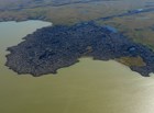 oblique aerial photo of a lava flow that extended into a body of water