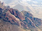 photo of hillside with layered rock outcrops