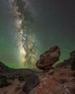 Balanced rock silhouetted by the night sky and the milky way.