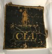 Square shaped bag depicting a man in a large hat and the letters OLI. 