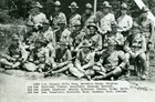 Black and white photo of over a dozen men in uniform with caption displaying all of their names. 