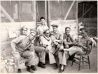 men sitting outside having fun. 