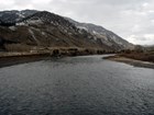 A river flowing through a landscape of snowy hills.