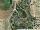 Aerial view of the bighorn river, surrounding lands, and the monitoring site on a bend in the river.