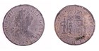 A front and back view of an old coin with pitting and a man's face in profile on it.
