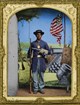 African American Civil War soldier posing with two weapons in front of a military backdrop.
