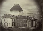 Black and White Photo of a courthouse with a large dome under construction in 1851. 