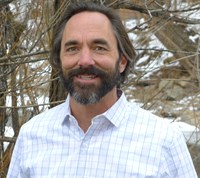 man with beard smiling at camera