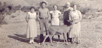 Members if the Smith family stand near the Frijole Ranch with a deer in the 1930s.