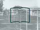 A collage of a black and white photo of a playground and the outline of an open book