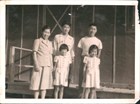 Japanese American family: a mother, two adult sons, and young twin girls