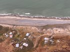 An aerial view of a storm-damaged coastline.