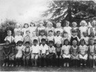 black and white school photo with 3 rows of elementary students