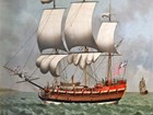 18th century ship on the high seas with sails open.