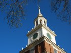 Close up of the clock tower of Independence Hall with clear blue sky background.