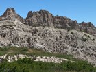 Photo of rocky cliff and badlands topography.