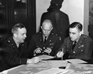A black and white image of General Eisenhower and two other officers at the War Department in 1942