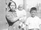 Black and white portrait of Chinese woman with young boy and baby.