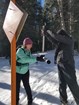 Two researchers weighing a tube filled with snow to figure out the amount of moisture in the snow.