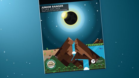 Eclipse Explorer Junior Ranger booklet wiht colorful image of eclipse over mountain.
