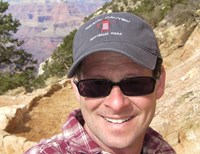 Man smiling for for selfie with sunglasses on