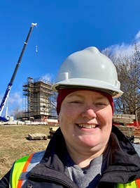 Christina Watson smiles for a selfie in a white hardhat.