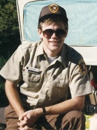 Tom Medema smiling for a photo while wearing a volunteer uniform.