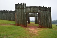 a wooden gate in an open field