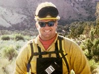 A person in a yellow hardhat and personal protective equipment.