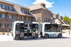 Electric Vehicle parked in front of a building with blue skies above.