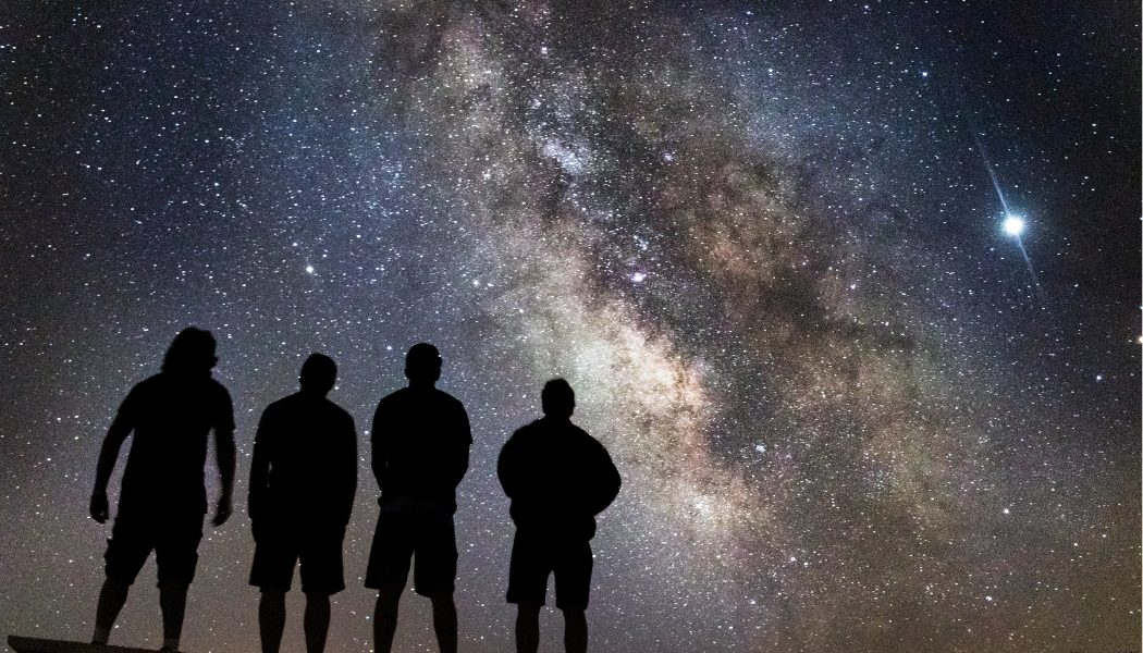 image of stargazers looking up at the night sky