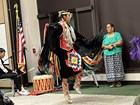 a woman dancing in ceremonial clothes