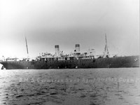 A large ship with two smokestacks and two masts.