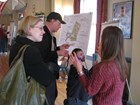 Two National Park Service employees talk with two members of the public. 