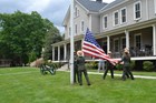 Park rangers raise an American flag.