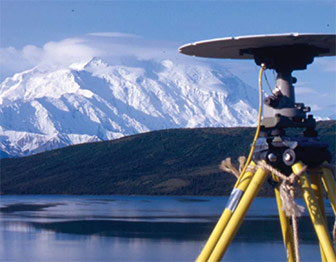 Scientific equipment stands in front of Mt. McKinley