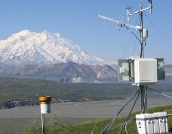 Weather station sitting on a hill in front of Mt. McKinley