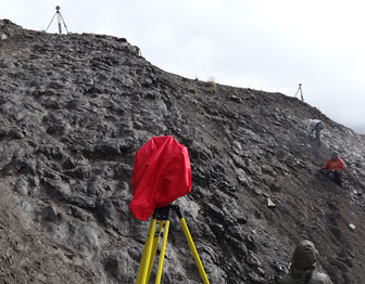 Lidar equipment sits on a hillside covered in fossils