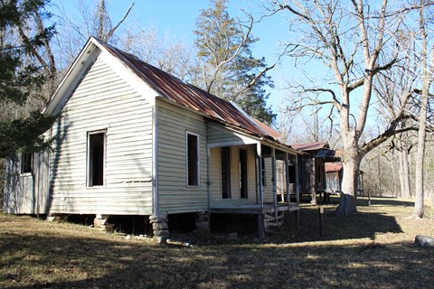A weathered old house stands in the Rush Historic District.
