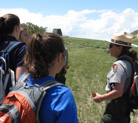 A ranger talks to a group of people