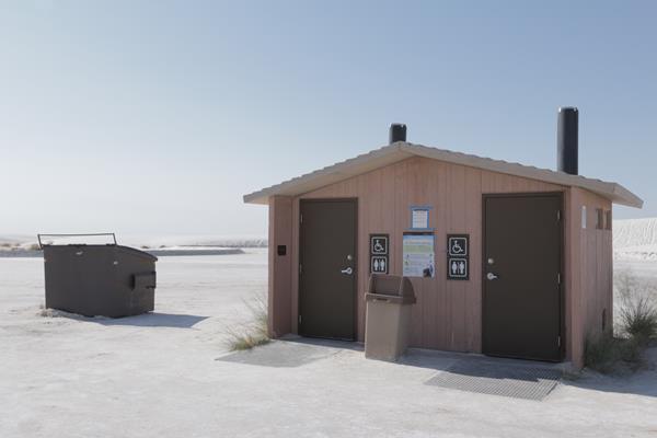 The Alkali Flat restroom, with its trash and dumpster receptacles.