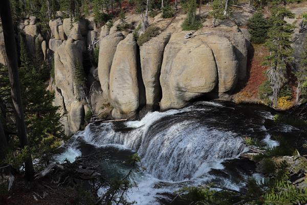 A creek cascades down terraces in a canyon.