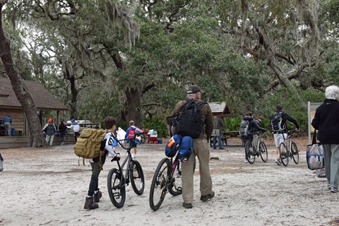 Visitors pushing thier bikes onto the island
