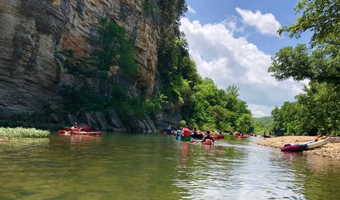 Many visitors paddle down the river.